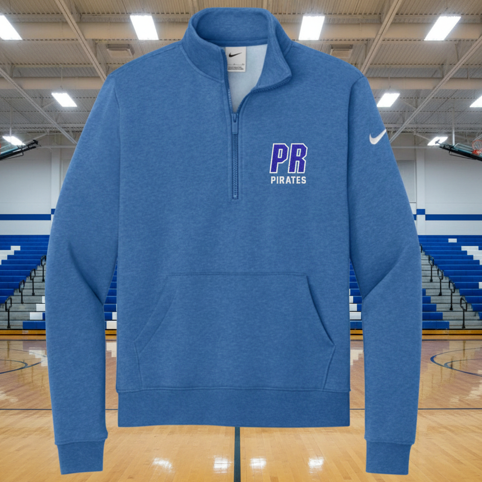 A heather blue Nike quarter-zip pullover sweatshirt with a white swoosh on the left sleeve and 'PB PIRATES' printed in purple and white on the left chest, shown on a plain white background.